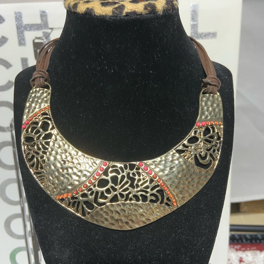 Gold Tone Bib Necklace With Pounded & Openwork Metal Designs With Orange Beads